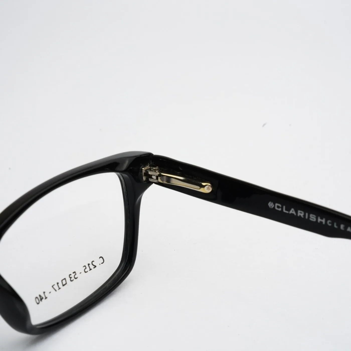 Macro detail of a Clarish™ acetate frame temple showing the printed brand mark