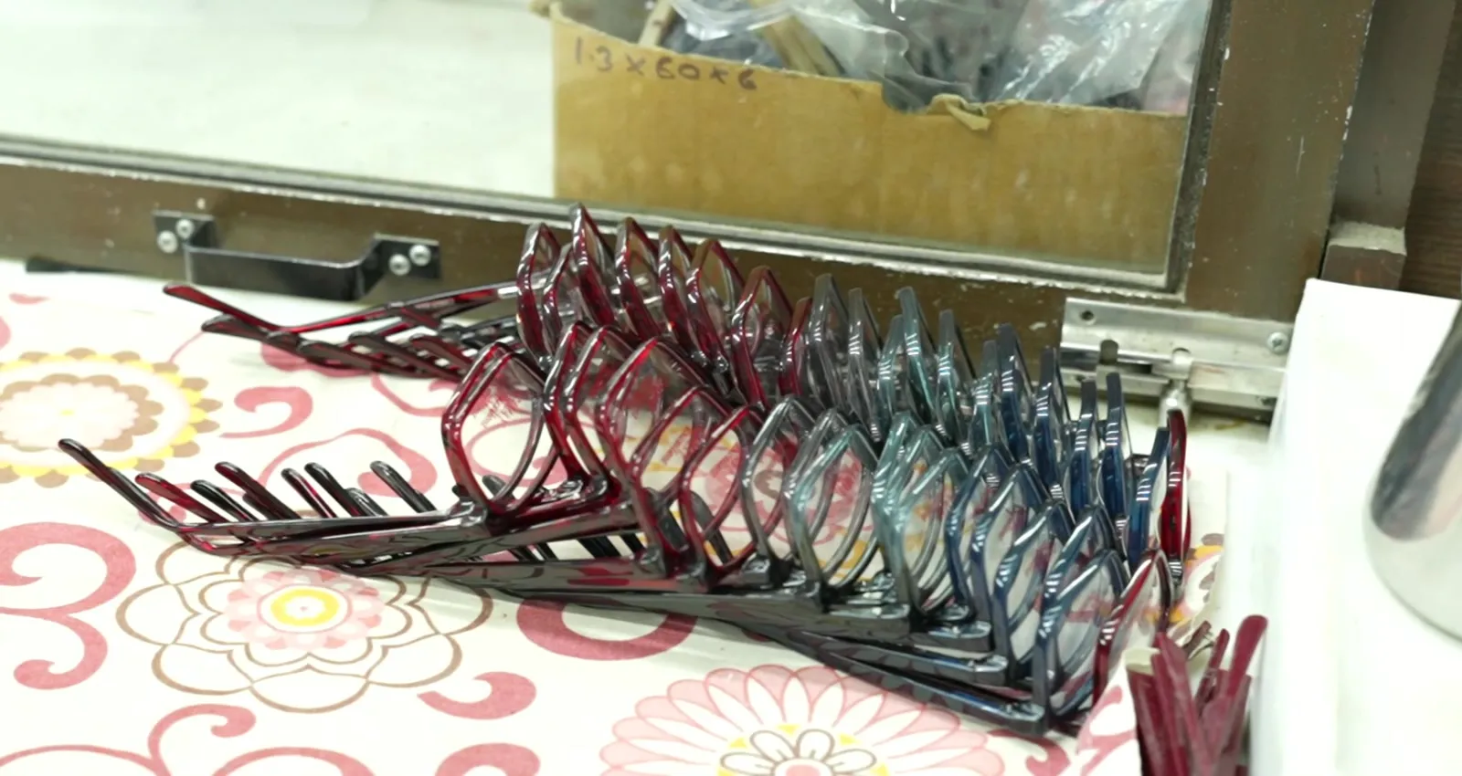 A rack of finished acetate frames in a run of colourways