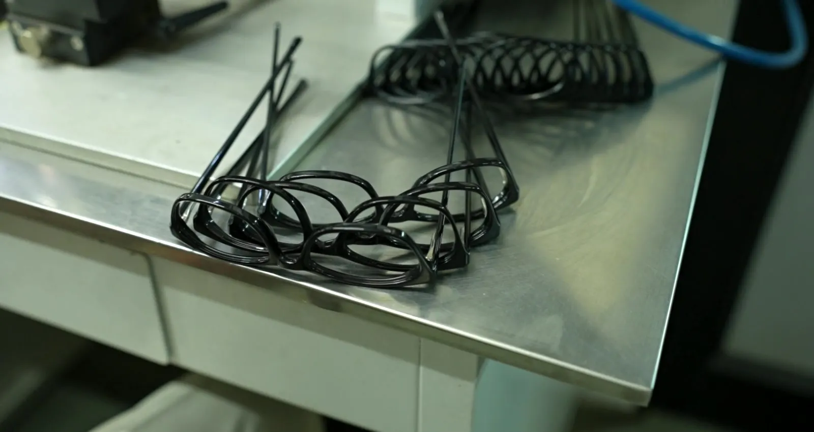 Steel core wires on the bench, before they are set into acetate temples